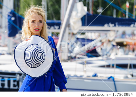 Fashion model wearing blue jumpsuit Fashion model wearing blue jumpsuit 137868994