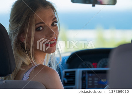 Young driver woman behind steering wheel Young driver woman behind steering wheel 137869010
