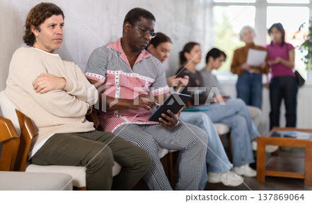 People are sitting in line and waiting for an interview People are sitting in line and waiting for an interview 137869064