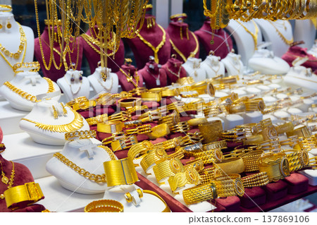 Variety of gold jewelry displayed for sale Variety of gold jewelry displayed for sale 137869106