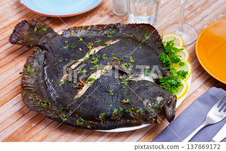 Baked brill fish with lemon and greens Baked brill fish with lemon and greens 137869172
