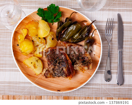 Dish of lamb leg with potatoes and pepper Dish of lamb leg with potatoes and pepper 137869191
