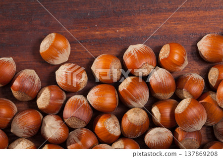 Image of dry unpeeled walnut on wooden surface, nobody Image of dry unpeeled walnut on wooden surface, nobody 137869208