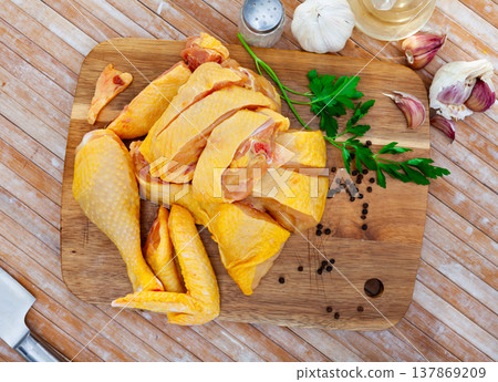 Raw sliced chicken on wooden cutting board Raw sliced chicken on wooden cutting board 137869209