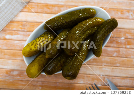 Pickled cucumbers on white plate, homemade preserves Pickled cucumbers on white plate, homemade preserves 137869238