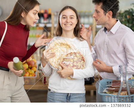 Daughter chose some pizzas in store, and quarrels with parents over choice of food Daughter chose some pizzas in store, and quarrels with parents over choice of food 137869332