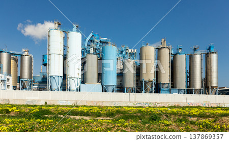 Outside view of factory with cylindrical metal constructions Outside view of factory with cylindrical metal constructions 137869357