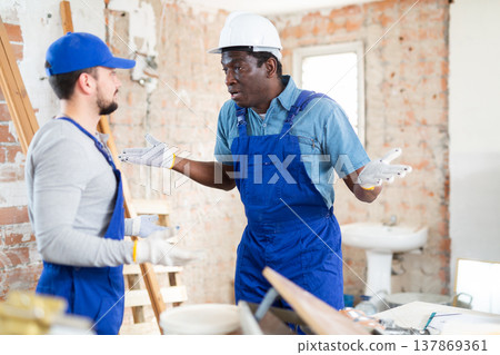 Two builders emotionally discuss working moments Two builders emotionally discuss working moments 137869361
