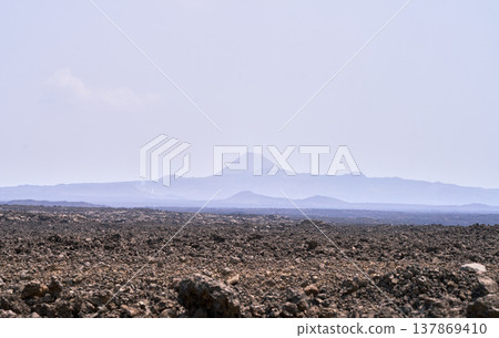 The volcanic landscape of the Danakil Depression in Ethiopia and the distant mountain ranges. The volcanic landscape of the Danakil Depression in Ethiopia and the distant mountain ranges. 137869410