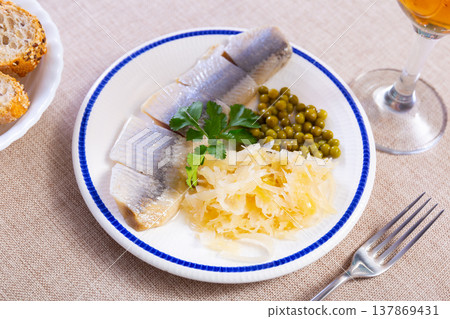 Light salted herring with marinated cabbage and green peas Light salted herring with marinated cabbage and green peas 137869431