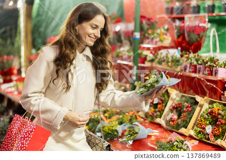 Cheerful woman looking for New Year decorations in street market 137869489