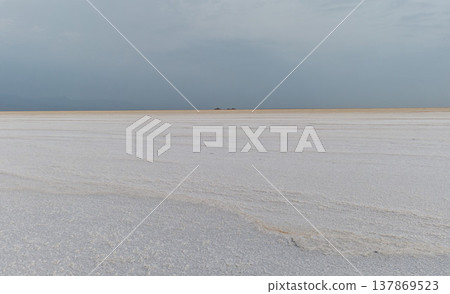The vast salt flats of Lake Asale in Ethiopia and the dramatic sky. 137869523