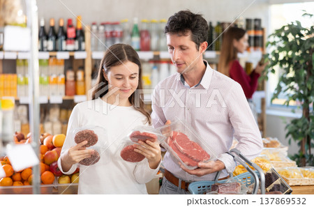 Man with his daughter chooses hamburger or entrecote Man with his daughter chooses hamburger or entrecote 137869532