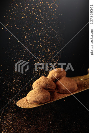 Chocolate truffles on a vintage brass cake server. Chocolate truffles on a vintage brass cake server. 137869541