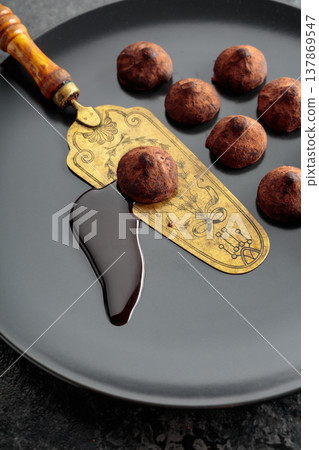 Chocolate truffles and vintage brass cake server. Chocolate truffles and vintage brass cake server. 137869547