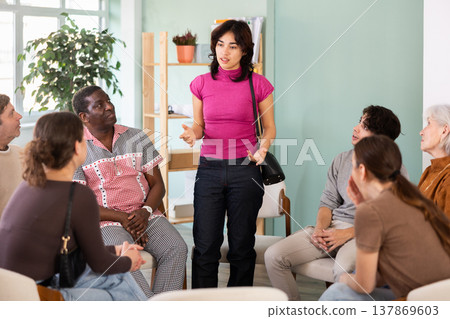 Malaysian woman communicates with people who sit in a circle against the office Malaysian woman communicates with people who sit in a circle against the office 137869603