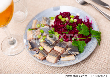 Nicely served sliced salted herring with beet salad on side 137869641
