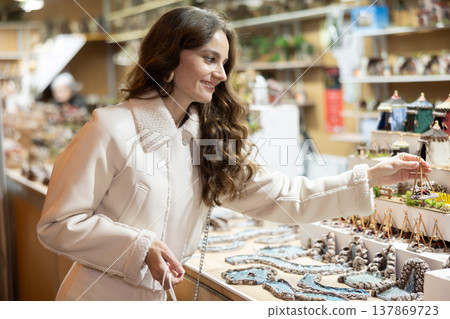 Woman choosing Christmas figurines 137869723