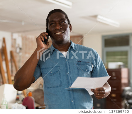 Man having telephone conversation in construction site Man having telephone conversation in construction site 137869730