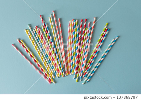 Colorful Paper Straws on Blue Background. Eco Party Supplies Colorful Paper Straws on Blue Background. Eco Party Supplies 137869797