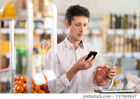 Adult man scanning qr code of beef entrecote Adult man scanning qr code of beef entrecote 137869847