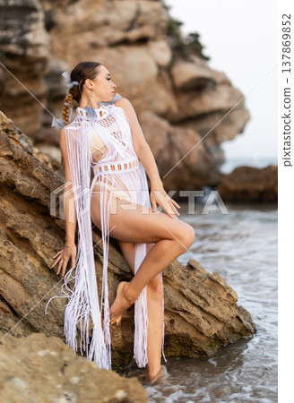 Barefoot girl on seashore in sexy and revealing Aztec carnival costume 137869852