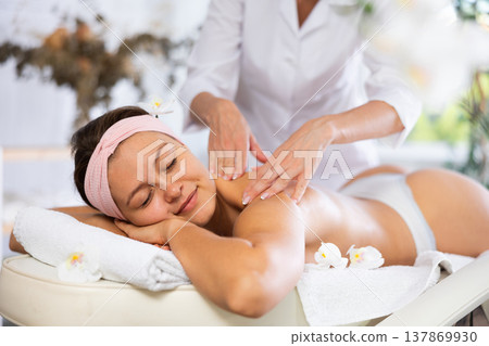 Young woman getting back and shoulder massage Young woman getting back and shoulder massage 137869930