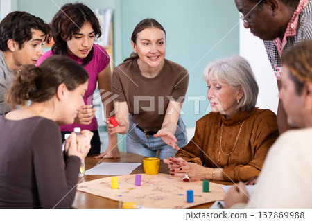 Group of different ages playing board game at table Group of different ages playing board game at table 137869988