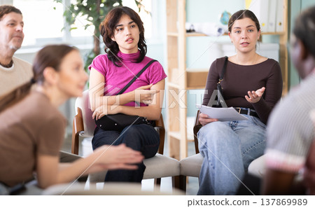 People sit in a circle and communicate in the interior of the office People sit in a circle and communicate in the interior of the office 137869989