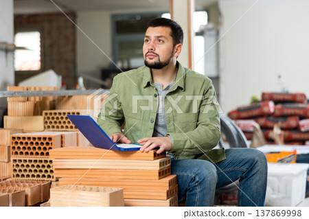 Owner checking home renovation plan on laptop 137869998