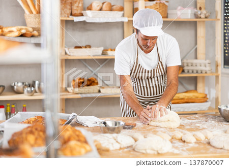 Caucasian guy works in bakery as baker, kneads dough, works with flour. 137870007
