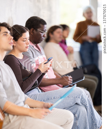 People are sitting in line and waiting for an interview People are sitting in line and waiting for an interview 137870015
