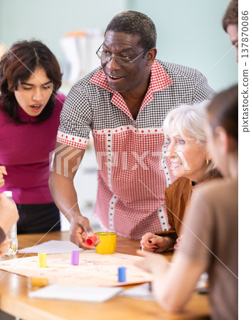 Group of people playing board game Group of people playing board game 137870086
