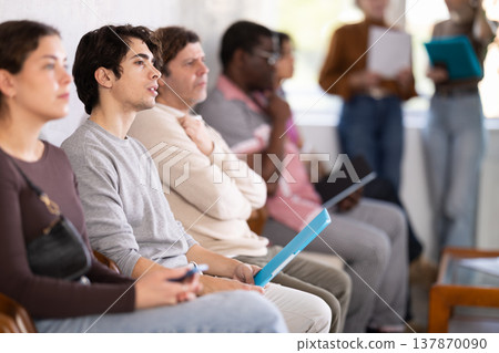 People are sitting in line and waiting for an interview People are sitting in line and waiting for an interview 137870090