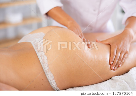 Close-up of young woman getting massage on her thighs and buttocks 137870104