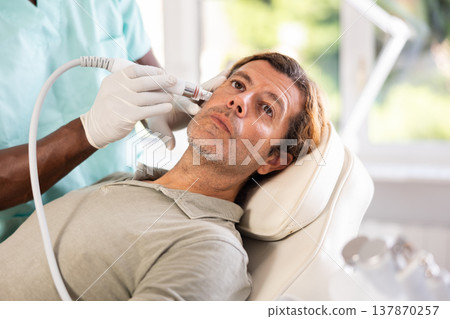doctor meticulously performs cosmetic procedure doctor meticulously performs cosmetic procedure 137870257