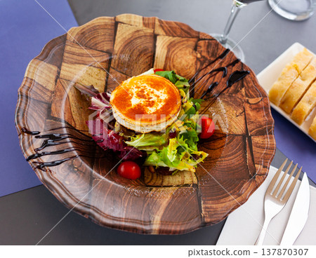 Salad with toasted goat cheese with fresh vegetables, greens, nuts Salad with toasted goat cheese with fresh vegetables, greens, nuts 137870307