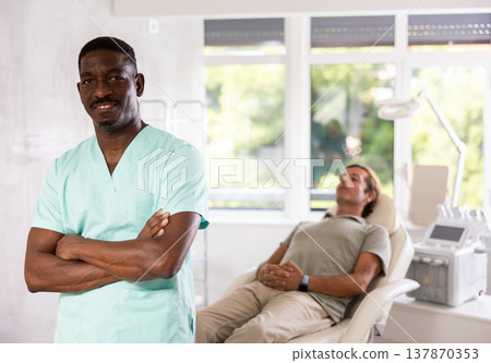 Confident professional African American cosmetologist standing in office 137870353