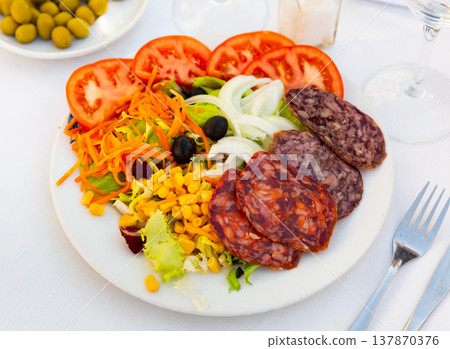 Catalan salad from greens and vegetables with various meat products Catalan salad from greens and vegetables with various meat products 137870376