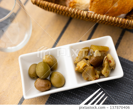 Pickled eggplant and olives on a table in restaurant Pickled eggplant and olives on a table in restaurant 137870406