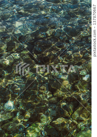 Sea texture or background. Stones with turquoise sea water. 137870667