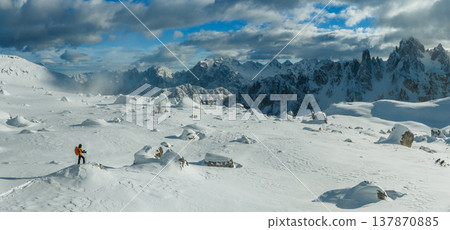 Beautiful Winter Dolomite Mountain Scenery with Man on Cross-Country Skis , Aerial View Beautiful Winter Dolomite Mountain Scenery with Man on Cross-Country Skis , Aerial View 137870885