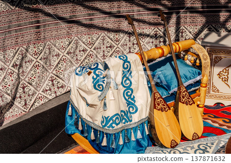 Musical Scene Setup. Ancient Wooden Instruments And Textiles Creating Festive Atmosphere Musical Scene Setup. Ancient Wooden Instruments And Textiles Creating Festive Atmosphere 137871632