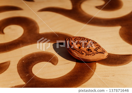 Artisan Crafted Clay Ocarina With Intricate Wood Pattern And Subtle Shadow Effects 137871646