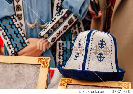 Cultural Market Scene Featuring Handcrafted Kalpak Hats With Ornate Embroidery And Vibrant Fabrics Cultural Market Scene Featuring Handcrafted Kalpak Hats With Ornate Embroidery And Vibrant Fabrics 137871758