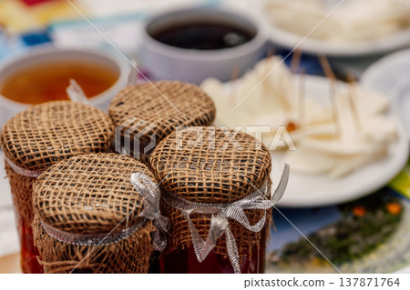 Vintage Preserve Display. Countrystyle Jam Jars Decorated With Fabric And Elegant Bows 137871764