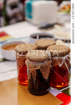 Vivid Imagery Of Homemade Preserves Displayed On Country Style Marketplace Table With Warm Ambiance 137871869