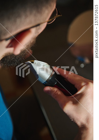 Man Trimming Beard With Electric Trimmer Close-Up Personal Grooming At Home Man Trimming Beard With Electric Trimmer Close-Up Personal Grooming At Home 137872615