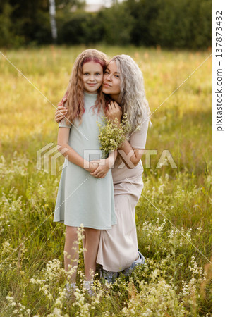 Radiant Outdoor Scene Showing Maternal Love With Wildflowers And Joyful Expressions 137873432
