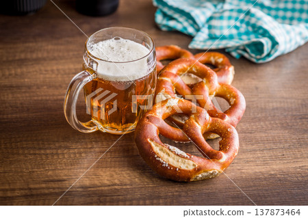 Beer Mug and Soft Pretzels on Rustic Wooden Table. Oktoberfest Snack and Bavarian Pub Food Beer Mug and Soft Pretzels on Rustic Wooden Table. Oktoberfest Snack and Bavarian Pub Food 137873464